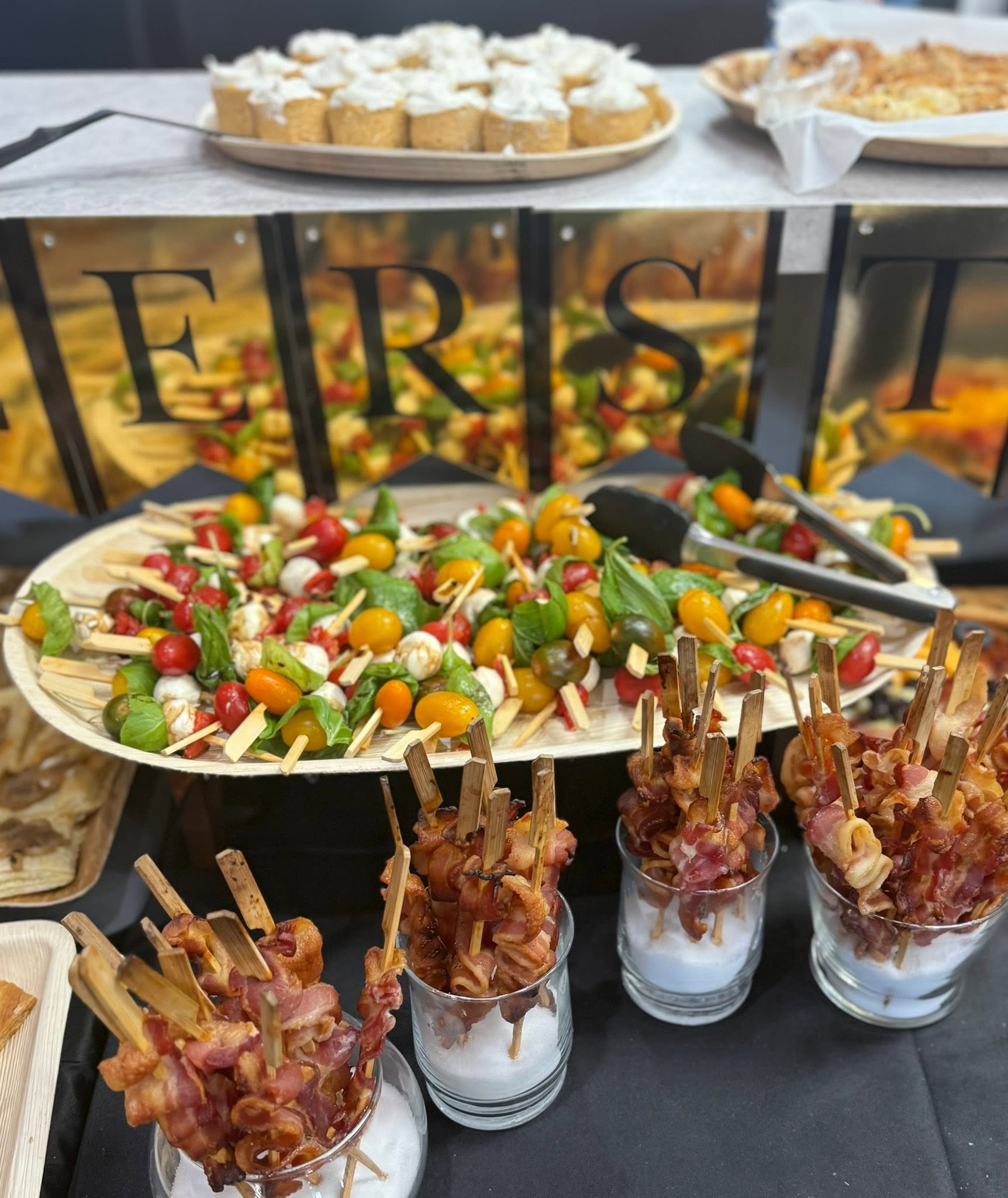 Sunnyside catering appetizers with tomato skewers, bacon skewers and small desserts
